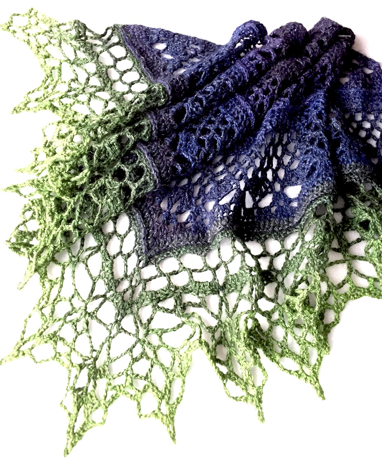 image of shawl crocheted by Glenda Waterworth in handspun wool in a blue to green gradient